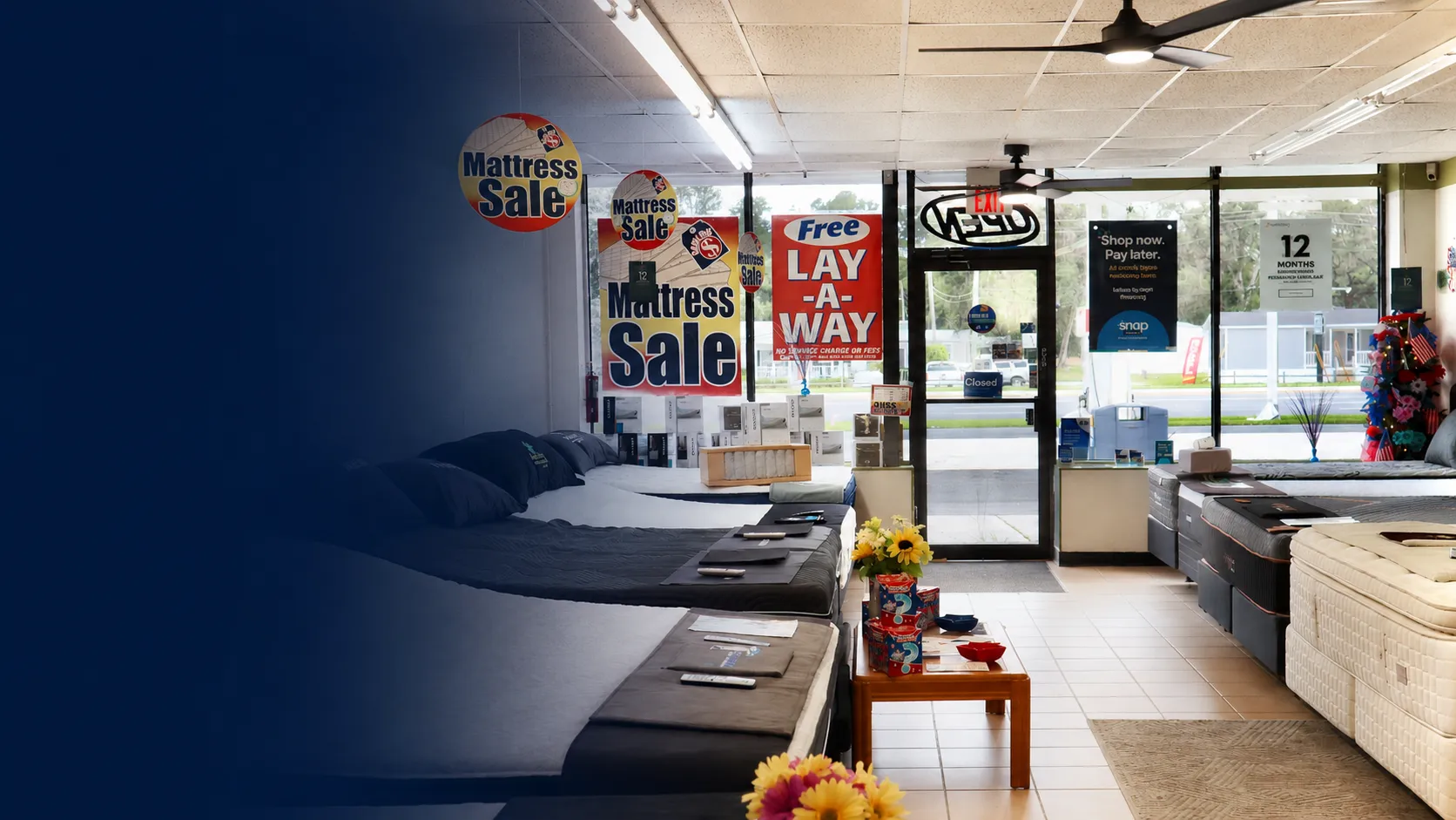 Customers relaxing on mattresses inside the Sleep World showroom in Brooksville